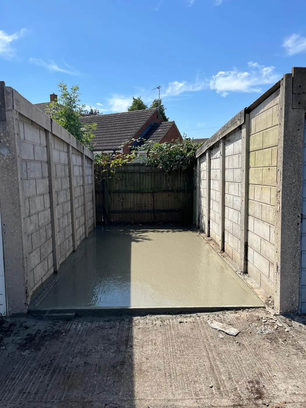 Freshly poured base in a walled side passage