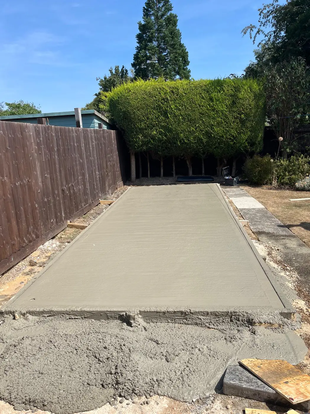 Long garden building base under clear blue sky