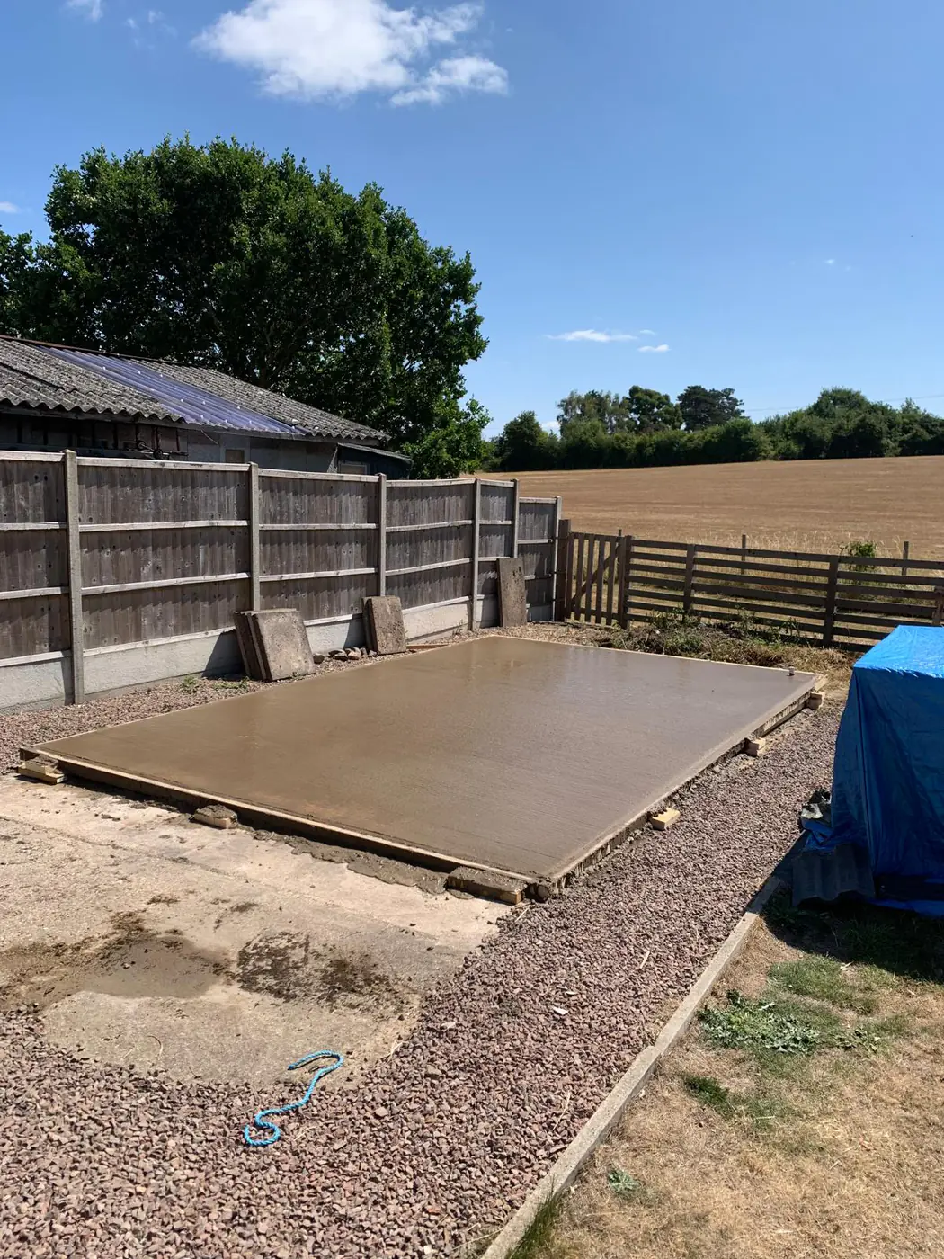 Freshly poured base with open farmland behind