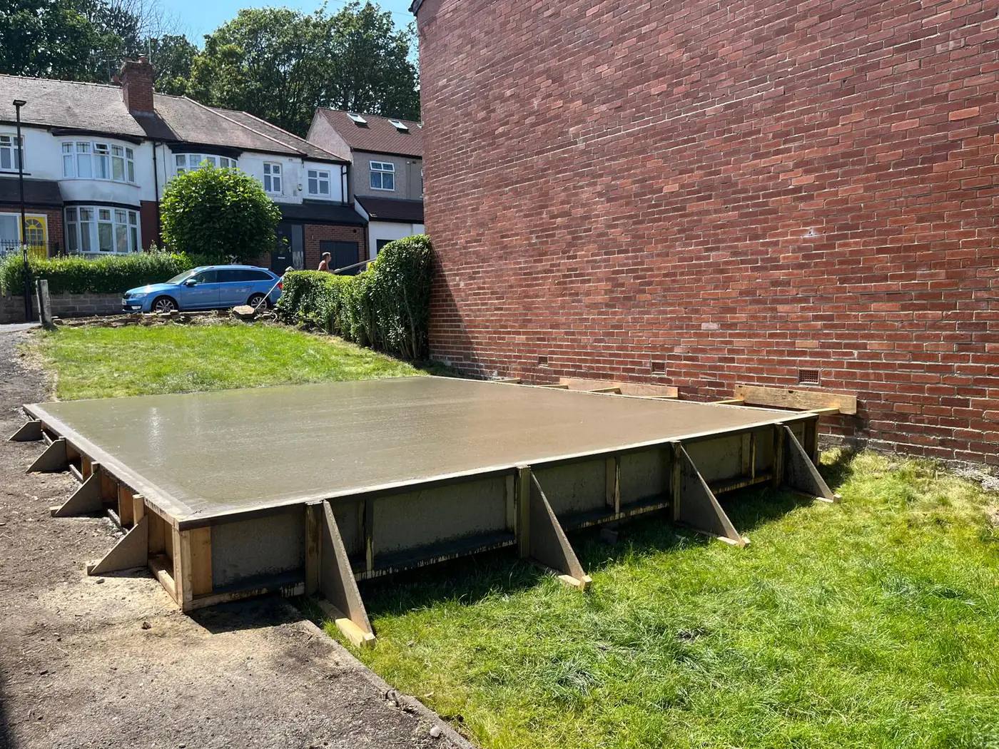 Base poured to shuttered formwork on a corner plot