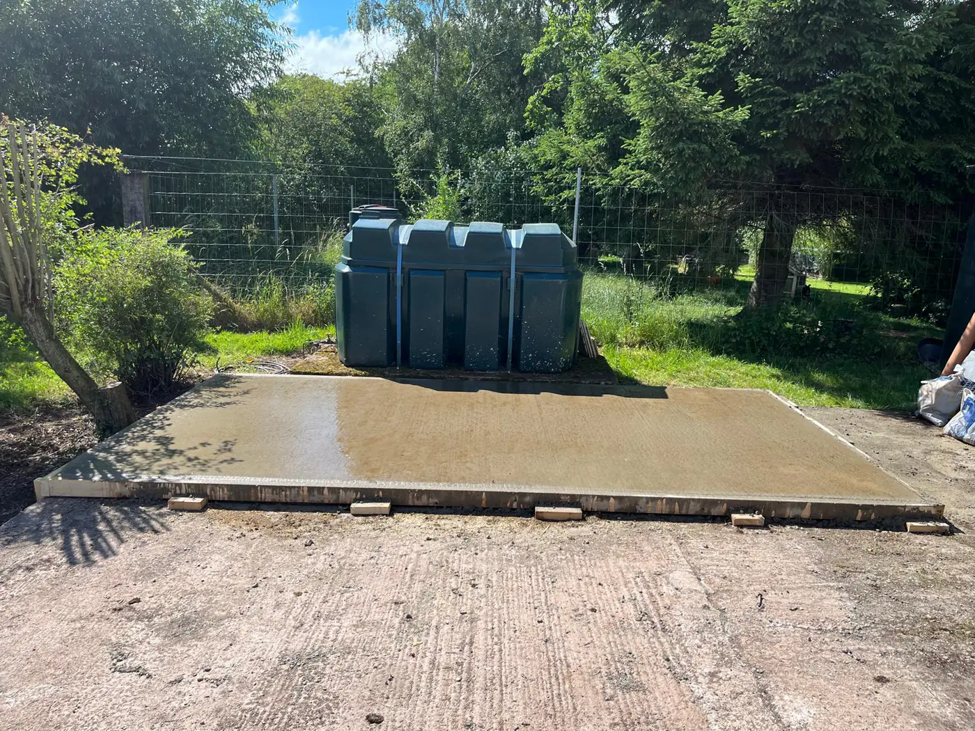 Freshly poured base on a woodland-edge plot