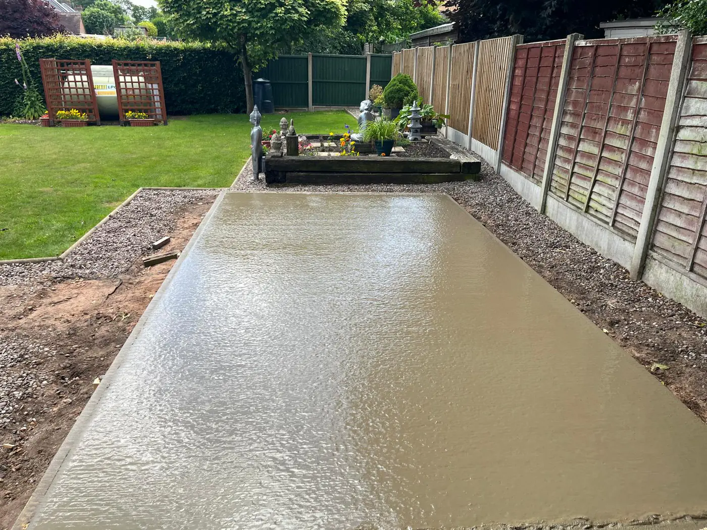 Freshly poured base in a landscaped ornamental garden
