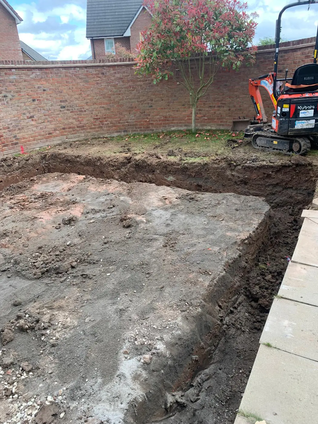 Mini digger excavating a new base
